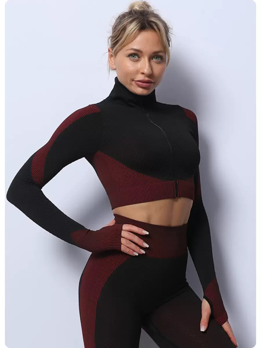 A three-piece athletic set consisting of a sports bra, leggings, and a zip-up jacket.