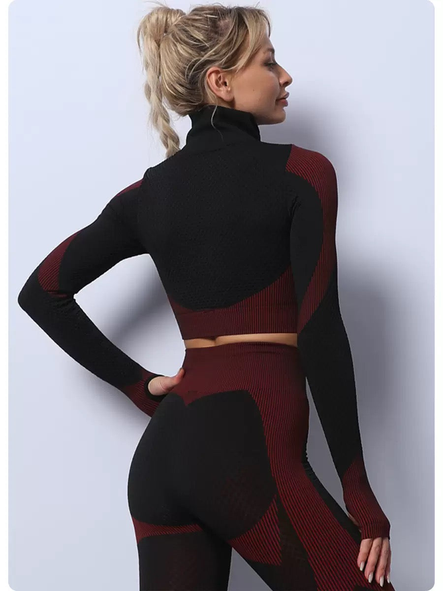 A three-piece athletic set consisting of a sports bra, leggings, and a zip-up jacket.