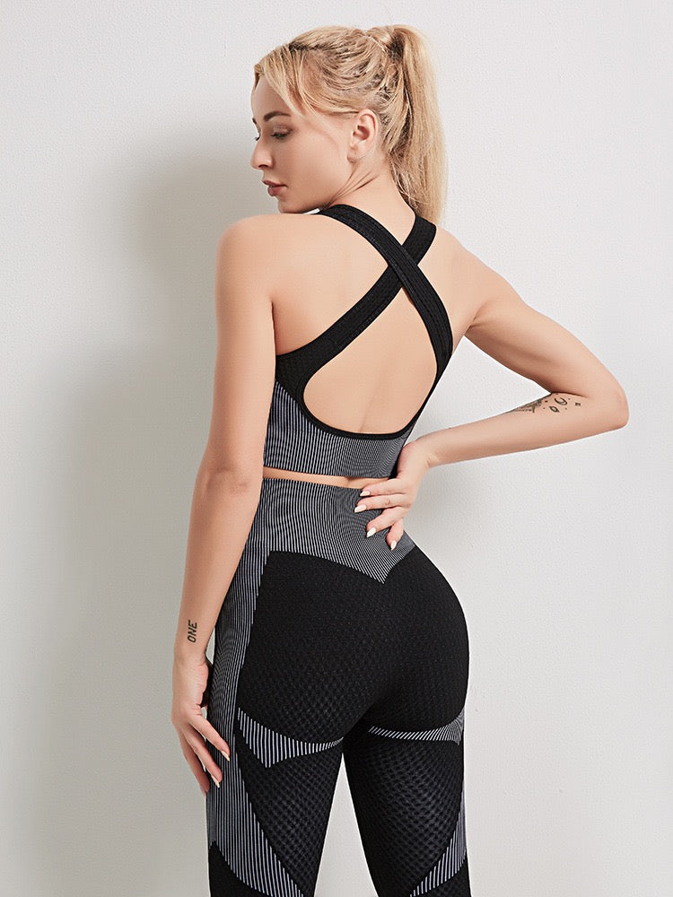 A three-piece athletic set consisting of a sports bra, leggings, and a zip-up jacket.