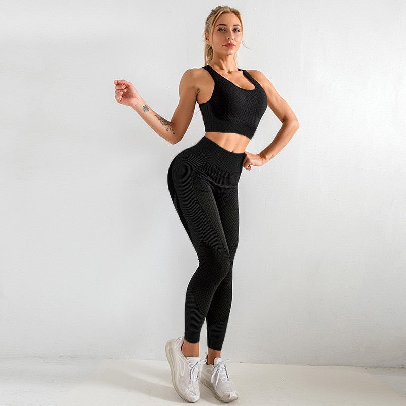 A three-piece athletic set consisting of a sports bra, leggings, and a zip-up jacket.