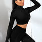 A three-piece athletic set consisting of a sports bra, leggings, and a zip-up jacket.