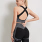 A three-piece athletic set consisting of a sports bra, leggings, and a zip-up jacket.