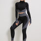 A three-piece athletic set consisting of a sports bra, leggings, and a zip-up jacket.
