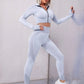 A three-piece athletic set consisting of a sports bra, leggings, and a zip-up jacket.