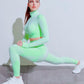 A three-piece athletic set consisting of a sports bra, leggings, and a zip-up jacket.
